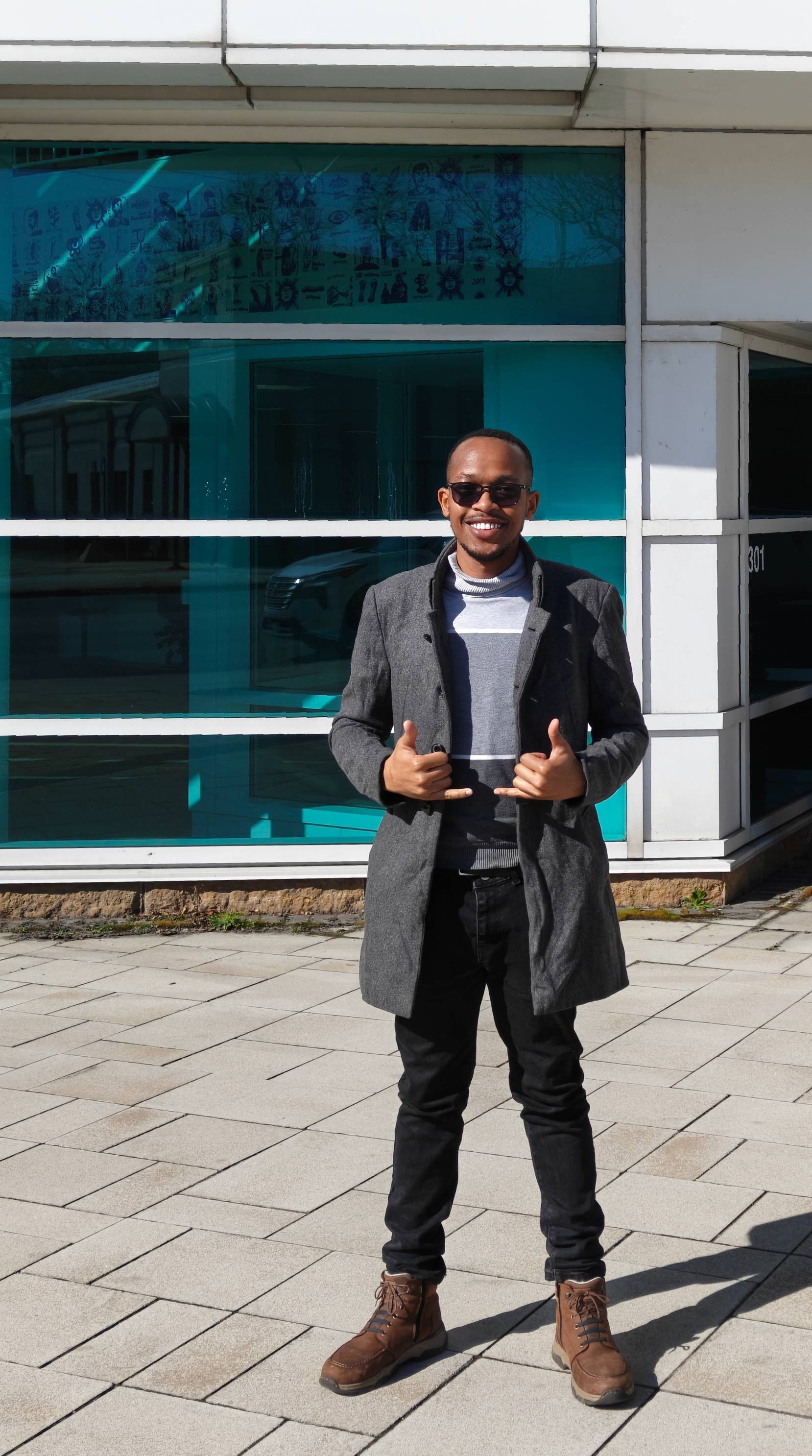 Man smiling at the camera with thumbs up